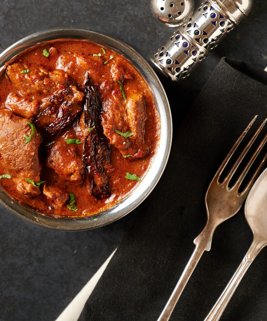 Serving dish full of lamb vindaloo from above.