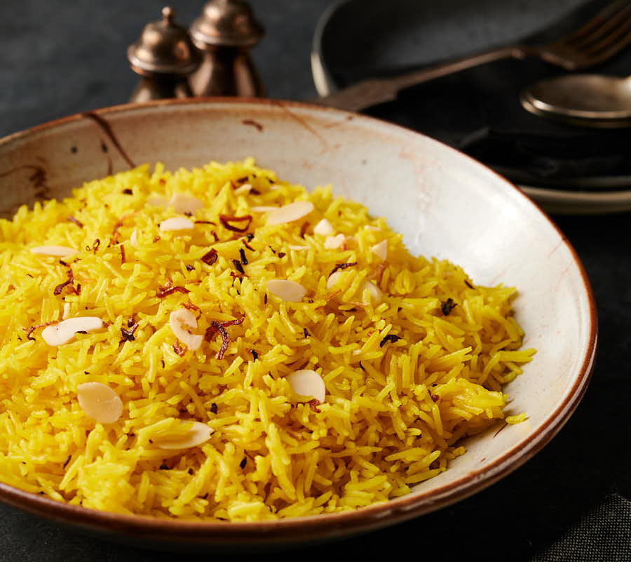Bowl of indian restaurant style rice pilau from the front.