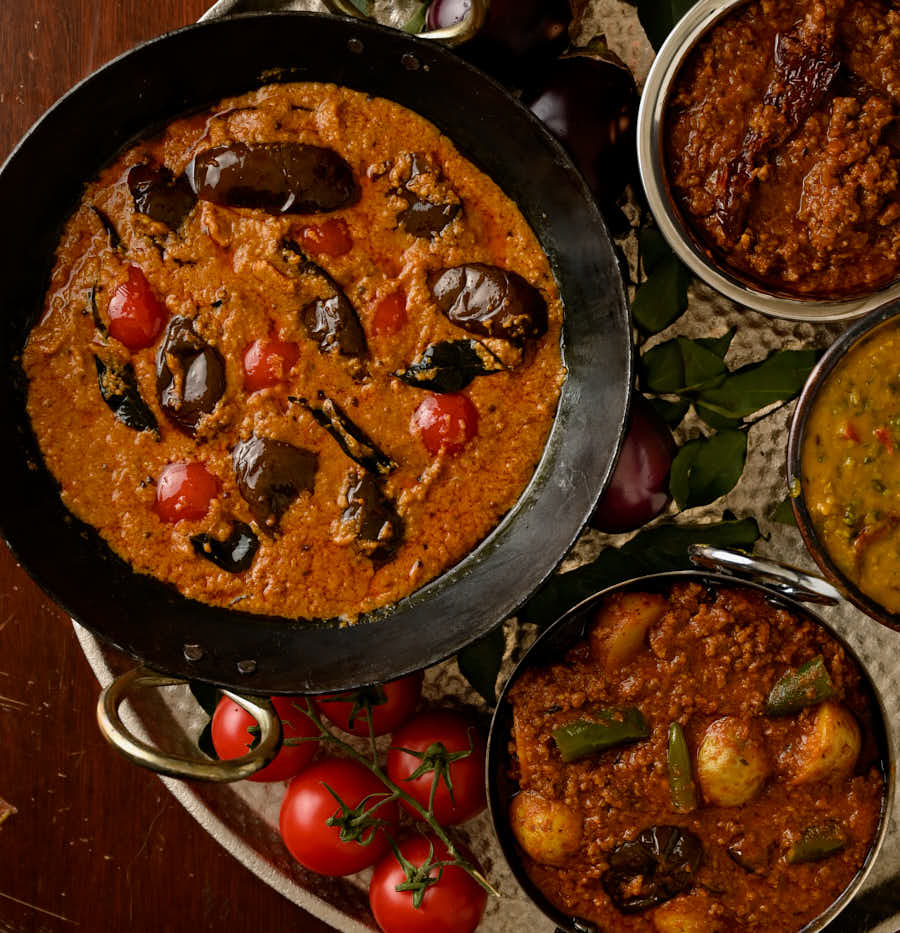 Table scene "thali" with surrounding curries from above.