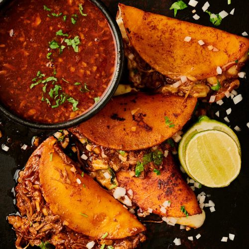 Birria tacos and consomé from above.